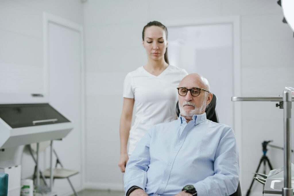 A doctor and senior patient in a modern medical clinic setting.