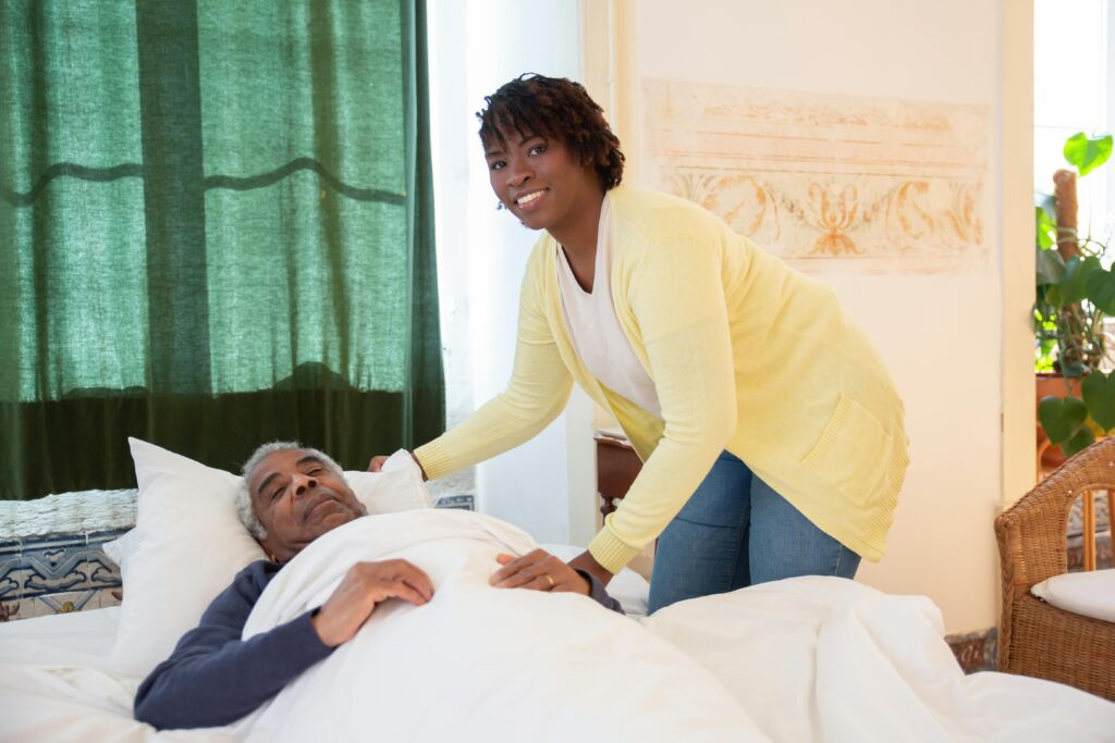 A woman tending to an elderly man in a bright and warm bedroom, symbolizing care and family support.